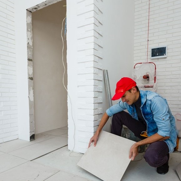 man installing a tile square